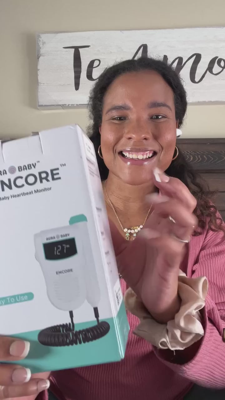 Pregnant woman using Aura Baby Encore Fetal Doppler
